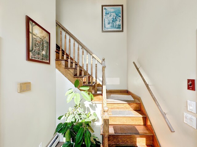 staircase featuring baseboard heating