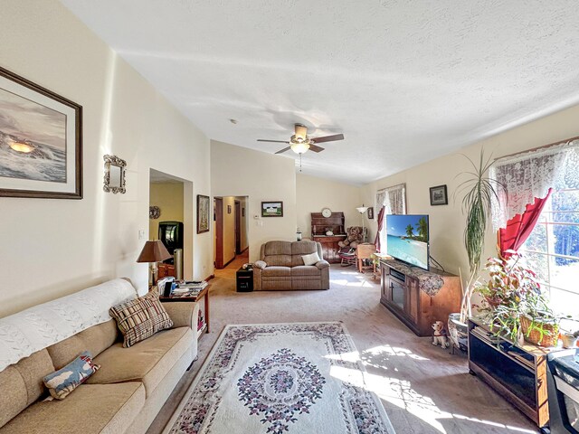 bedroom featuring vaulted ceiling, ceiling fan, carpet flooring, and a textured ceiling