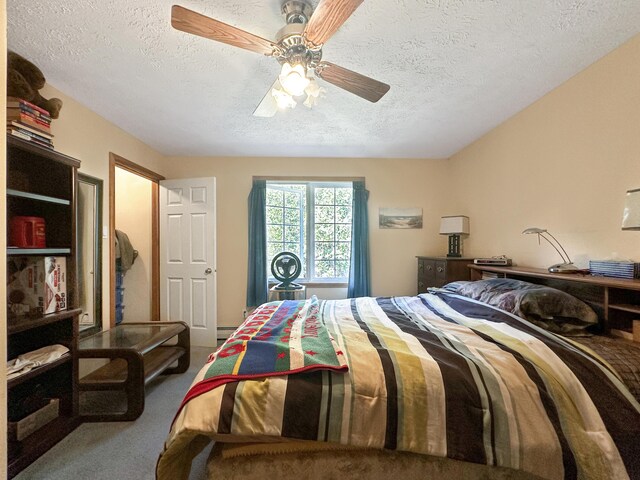 bedroom with a textured ceiling, ceiling fan, and carpet floors