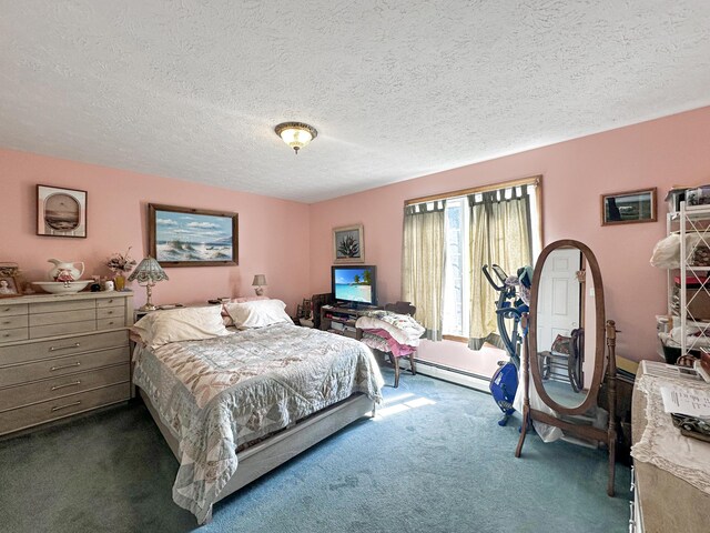 bedroom featuring a textured ceiling, a baseboard heating unit, and dark carpet