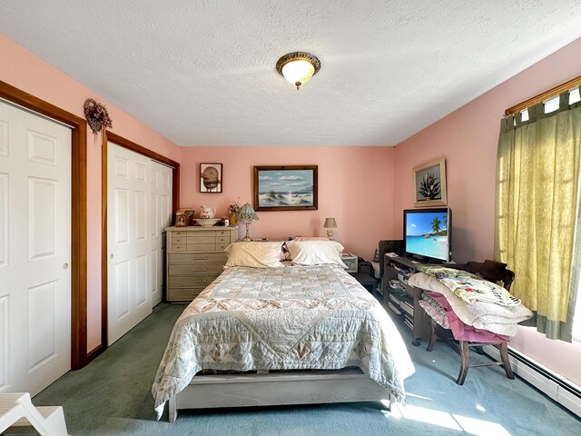 bedroom featuring carpet floors, a textured ceiling, baseboard heating, and a closet