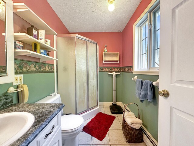 bathroom featuring a textured ceiling, a shower with door, tile patterned floors, vanity, and toilet