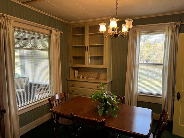 dining room with a notable chandelier and crown molding