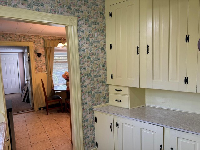 kitchen with light tile patterned floors and white cabinets