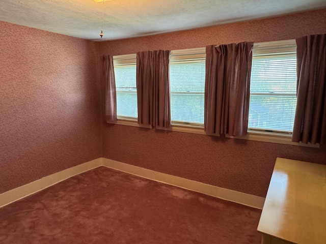 37 Fisher St, Fort Fairfield, ME 04742 - unfurnished room featuring dark colored carpet, baseboards, and a wealth of natural light