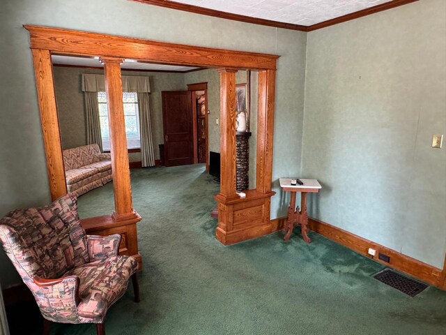 sitting room featuring ornamental molding and carpet