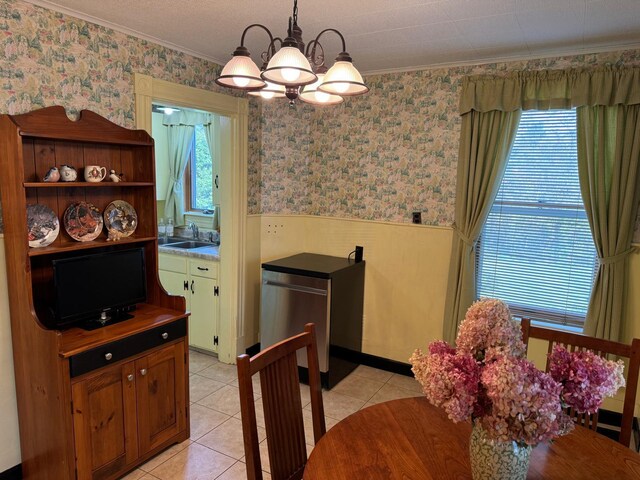 tiled dining room with a notable chandelier, crown molding, and sink