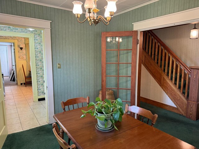 tiled dining room with ornamental molding and a notable chandelier