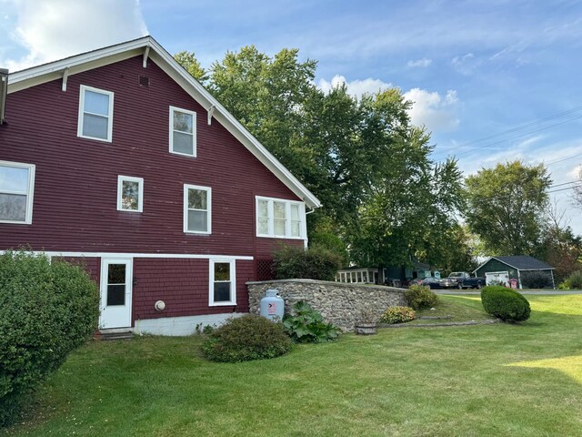 view of side of home featuring a lawn