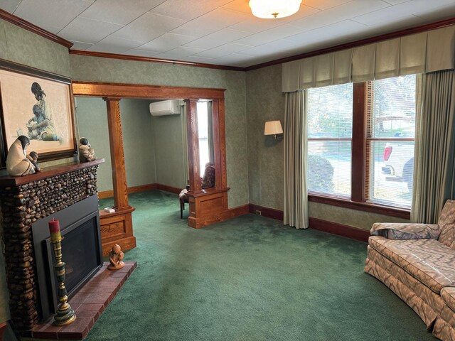 interior space featuring a fireplace, crown molding, a wall mounted air conditioner, and decorative columns