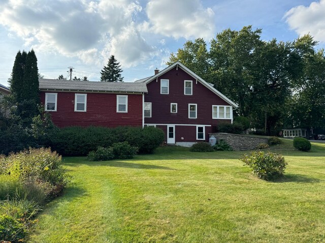 view of side of home featuring a yard