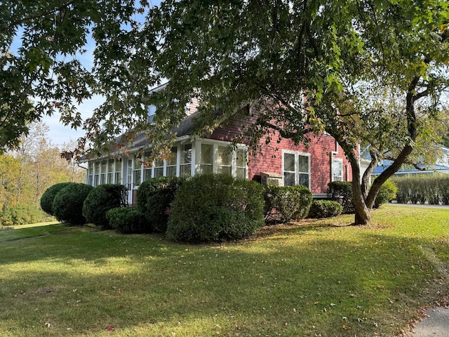 37 Fisher St, Fort Fairfield, ME 04742 - view of property exterior with a sunroom and a lawn
