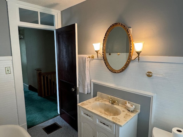 37 Fisher St, Fort Fairfield, ME 04742 - bathroom featuring toilet, vanity, wainscoting, and visible vents