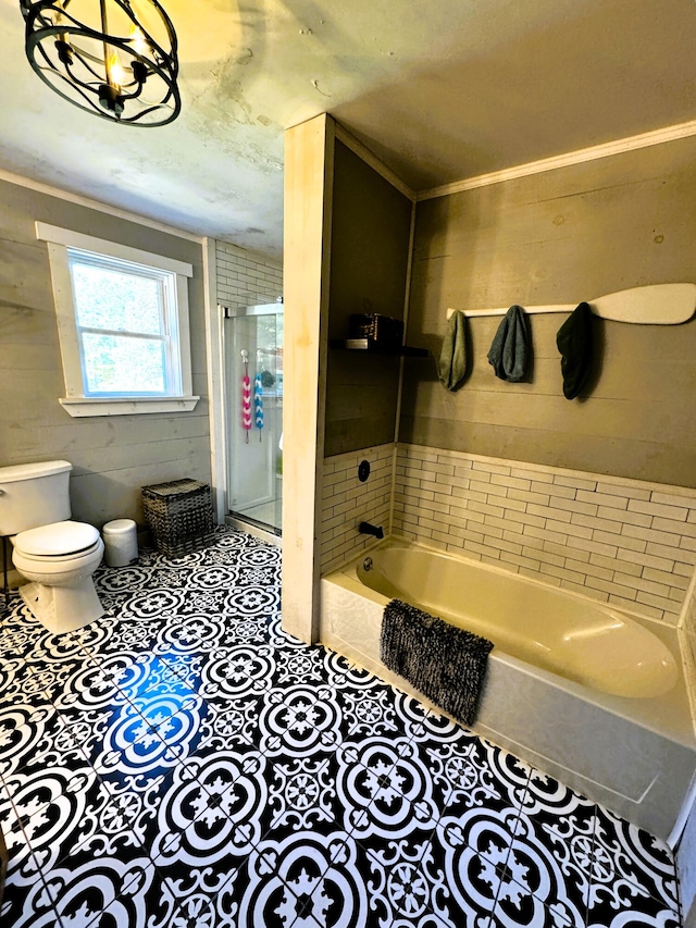 bathroom featuring shower with separate bathtub, tile patterned flooring, and toilet