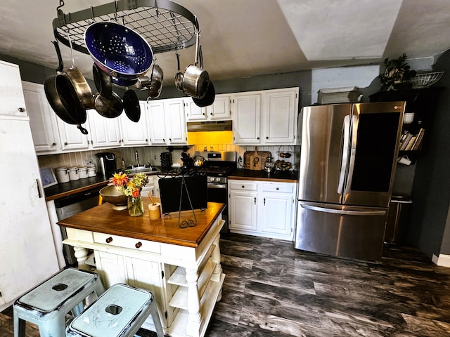 kitchen featuring stainless steel appliances, white cabinetry, and dark hardwood / wood-style floors