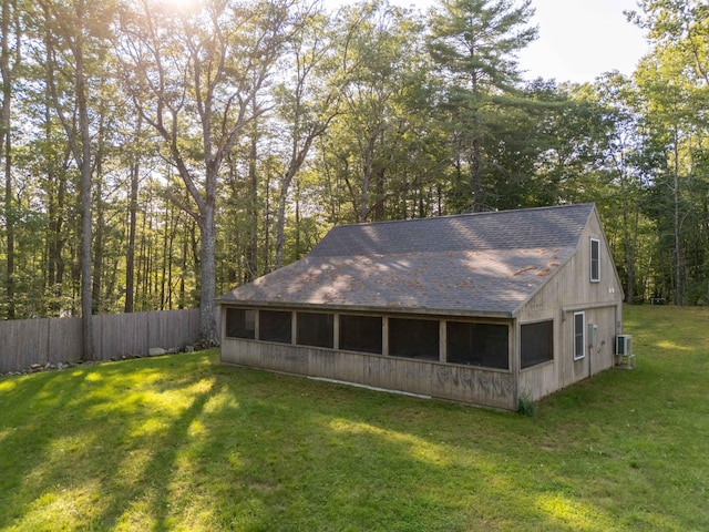 rear view of property with a lawn and central air condition unit