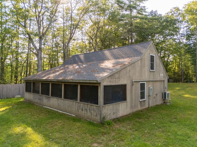 view of side of home with a lawn