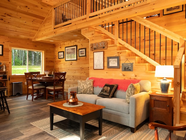 living room featuring wooden walls, wood ceiling, dark wood-type flooring, and high vaulted ceiling