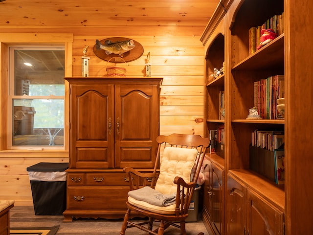 living area with wooden walls and wooden ceiling