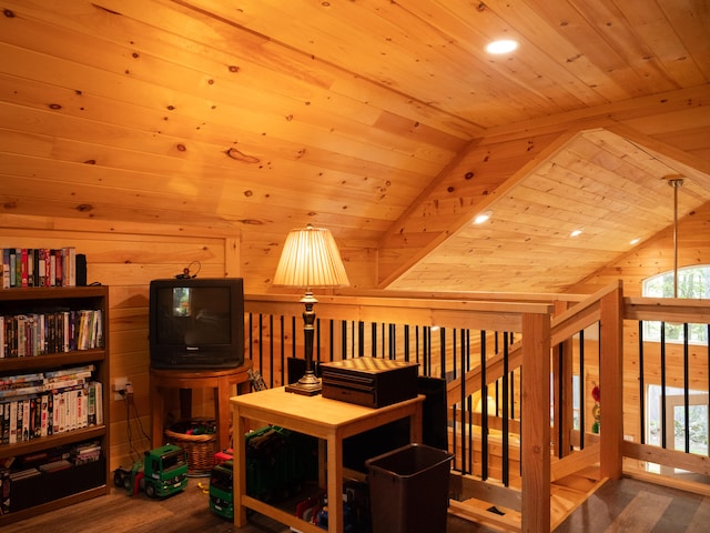 sitting room with lofted ceiling, wood ceiling, hardwood / wood-style flooring, and wooden walls