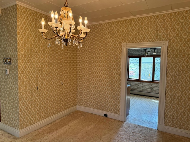 empty room featuring ornamental molding, a baseboard radiator, and a chandelier