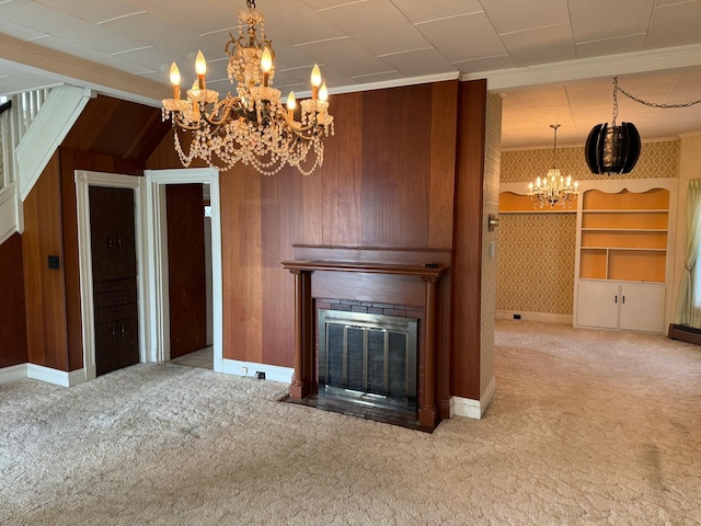 unfurnished living room with a fireplace, crown molding, wood walls, and carpet