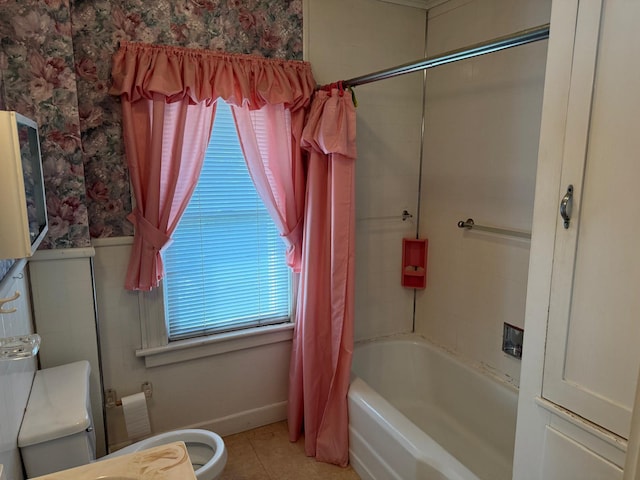 bathroom with a healthy amount of sunlight, tile patterned flooring, shower / tub combo with curtain, and toilet