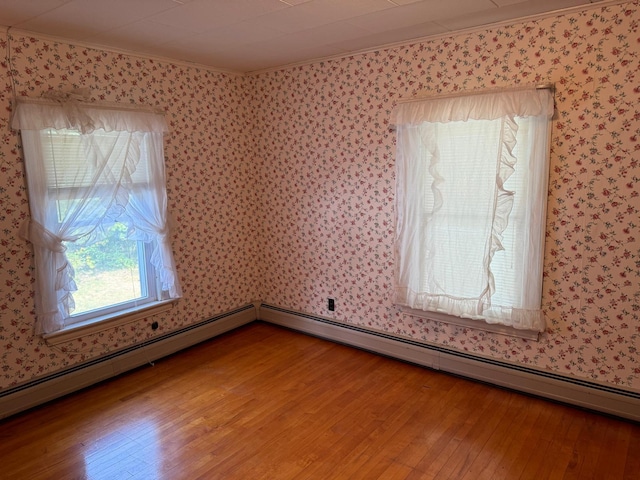 unfurnished room featuring wood-type flooring and crown molding