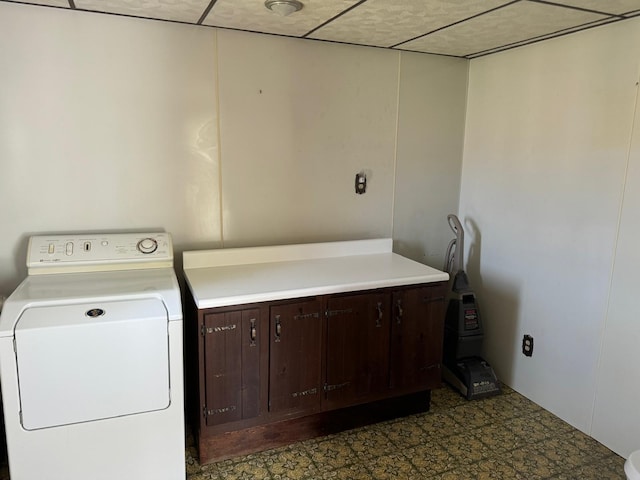 laundry area featuring washer / clothes dryer and cabinets