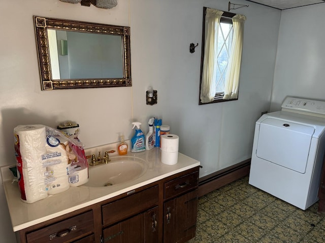 bathroom featuring washer / clothes dryer, vanity, and a baseboard heating unit