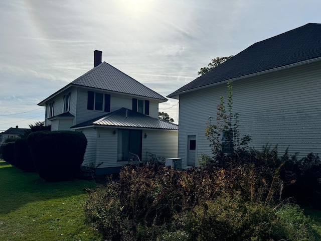 exterior space featuring a lawn and central AC