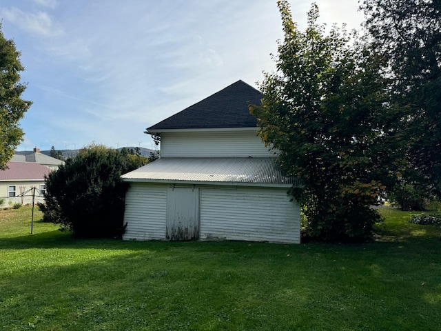 view of home's exterior featuring a shed and a lawn