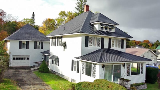 rear view of property featuring a garage