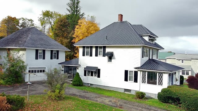 rear view of property featuring a garage