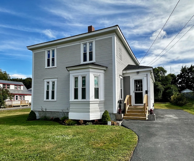 112 S St, Calais, ME 04619 - view of front of home featuring entry steps, a chimney, a front lawn, and driveway