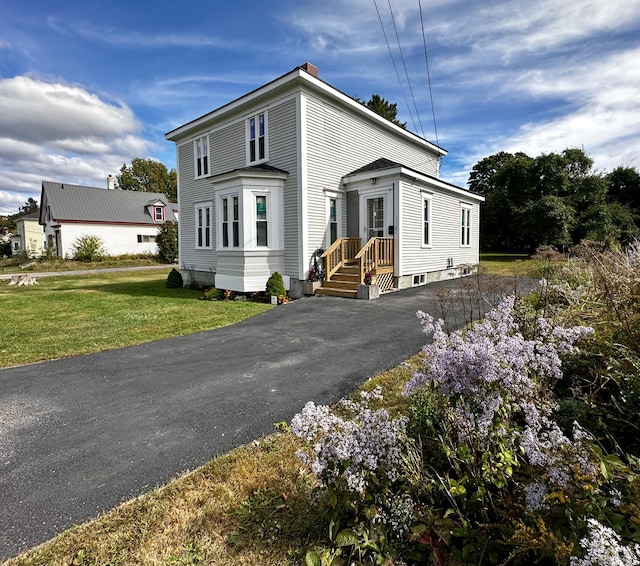 112 S St, Calais, ME 04619 - traditional style home with asphalt driveway, a front yard, and a chimney