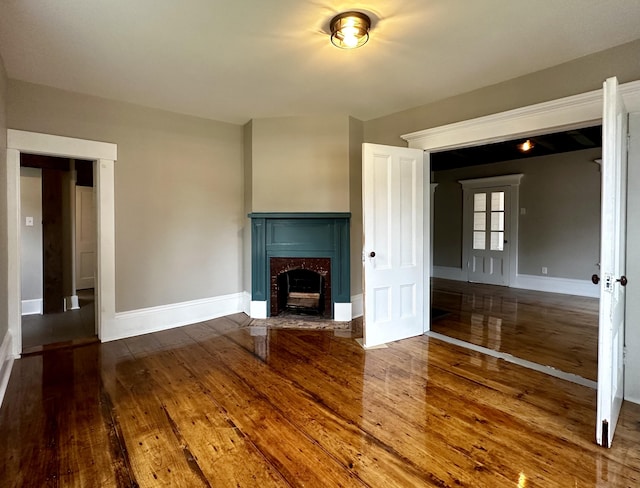 112 S St, Calais, ME 04619 - unfurnished living room with hardwood / wood-style flooring, baseboards, and a premium fireplace
