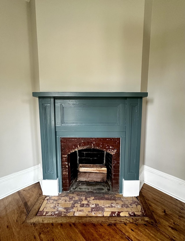 112 S St, Calais, ME 04619 - detailed view of a fireplace, baseboards, and wood finished floors