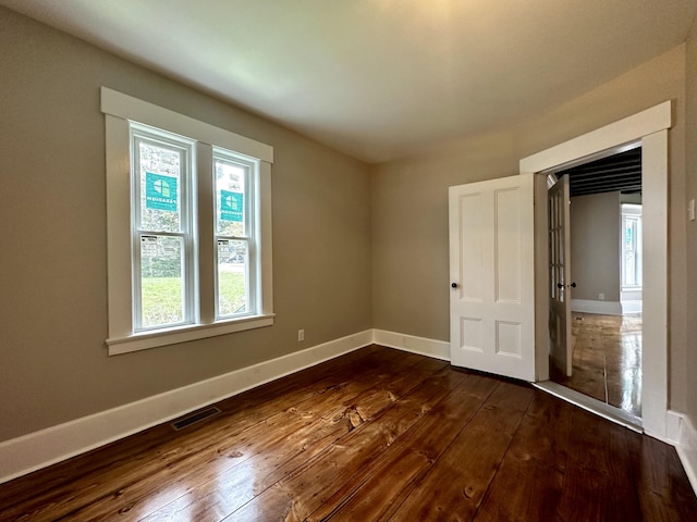 112 S St, Calais, ME 04619 - unfurnished bedroom with dark wood-style flooring and baseboards