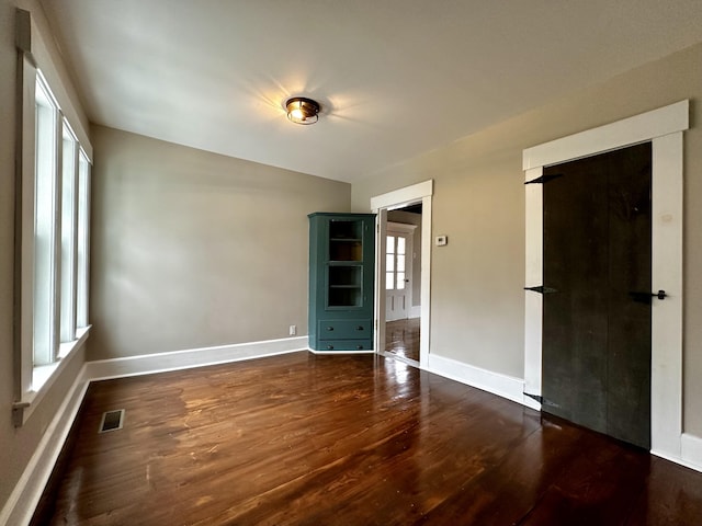112 S St, Calais, ME 04619 - empty room with dark wood finished floors and baseboards