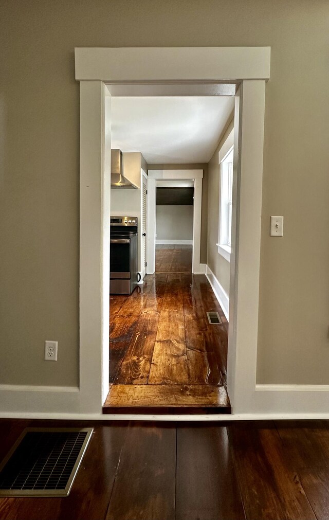 corridor with dark wood-type flooring