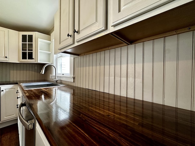 112 S St, Calais, ME 04619 - kitchen featuring a sink, wooden counters, white cabinetry, and glass insert cabinets