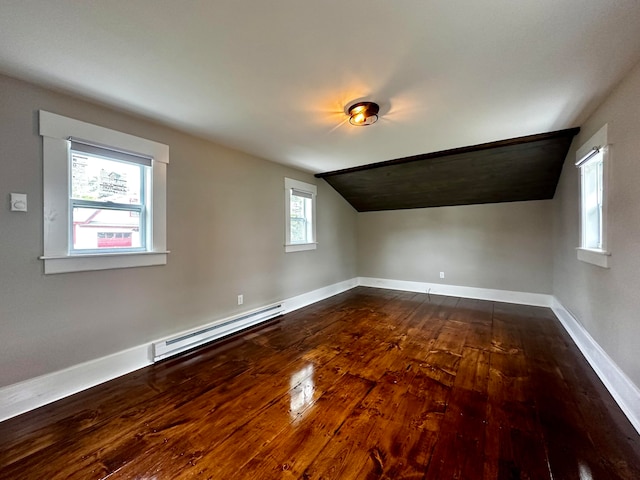 bonus room featuring a baseboard radiator, vaulted ceiling, dark hardwood / wood-style flooring, and a wealth of natural light