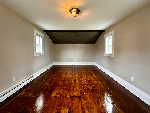 bonus room featuring a baseboard radiator, baseboards, and dark wood-type flooring