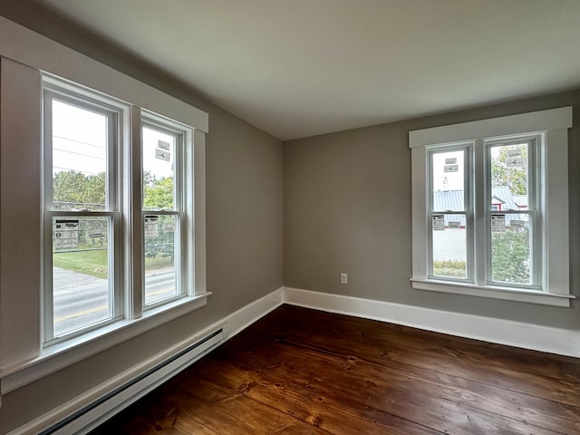 112 S St, Calais, ME 04619 - unfurnished room with a baseboard heating unit, plenty of natural light, baseboards, and dark wood finished floors