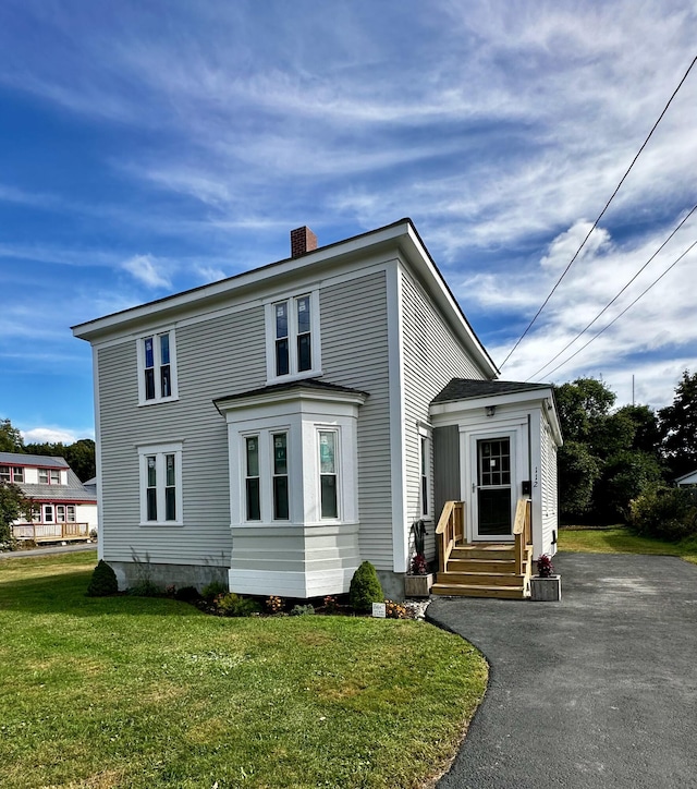 112 S St, Calais, ME 04619 - view of front of home featuring entry steps, a chimney, a front yard, and driveway
