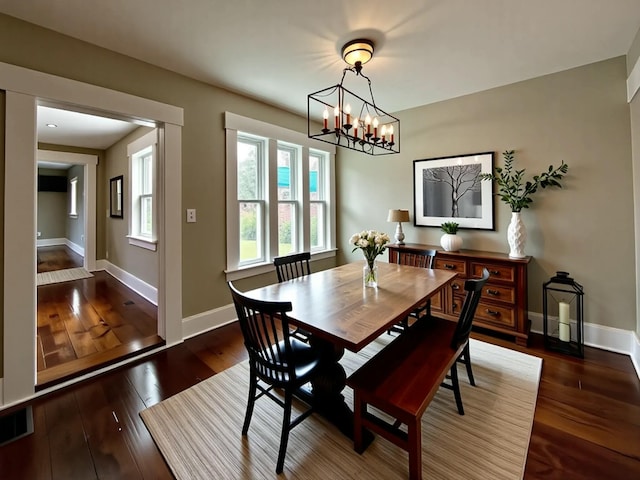112 S St, Calais, ME 04619 - dining room with a chandelier, baseboards, and hardwood / wood-style floors