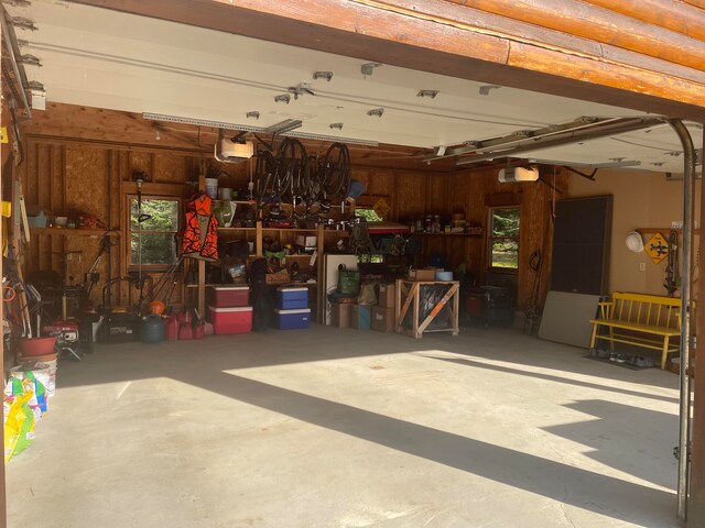 garage with a garage door opener and a workshop area