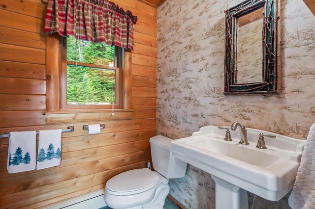 62 Antler Way, Rangeley, ME 04970 - half bathroom featuring wallpapered walls, toilet, a sink, and wood walls