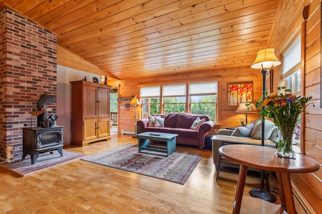 62 Antler Way, Rangeley, ME 04970 - living room featuring wooden ceiling, a wood stove, lofted ceiling, a baseboard radiator, and light wood finished floors